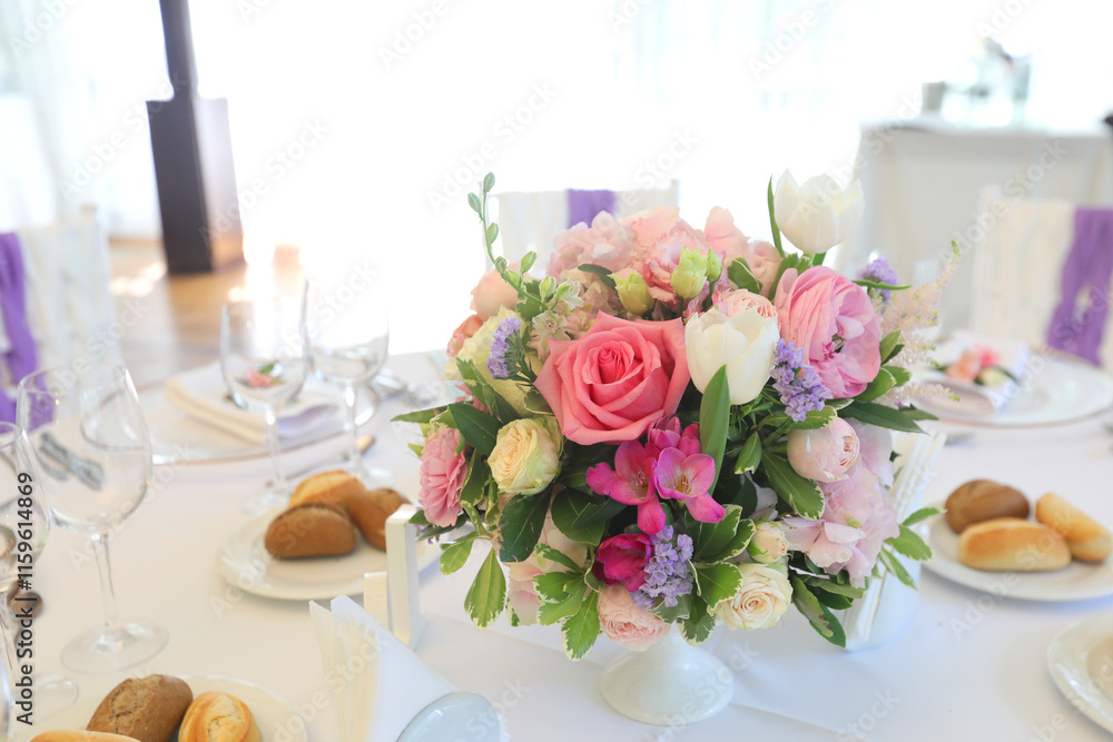 Beautiful table setting with tableware, flowers, accessories and beautiful rose for a party, wedding reception or holiday event. Photographed in ambiental light. Beautiful table setting with tableware, flowers, accessories and beautiful rose for a party, wedding reception or holiday event. Photographed in ambiental light.