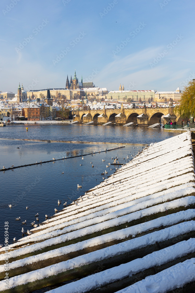 Snowy Prague Lesser Town with Prague Castle above River Vltava, Czech republic