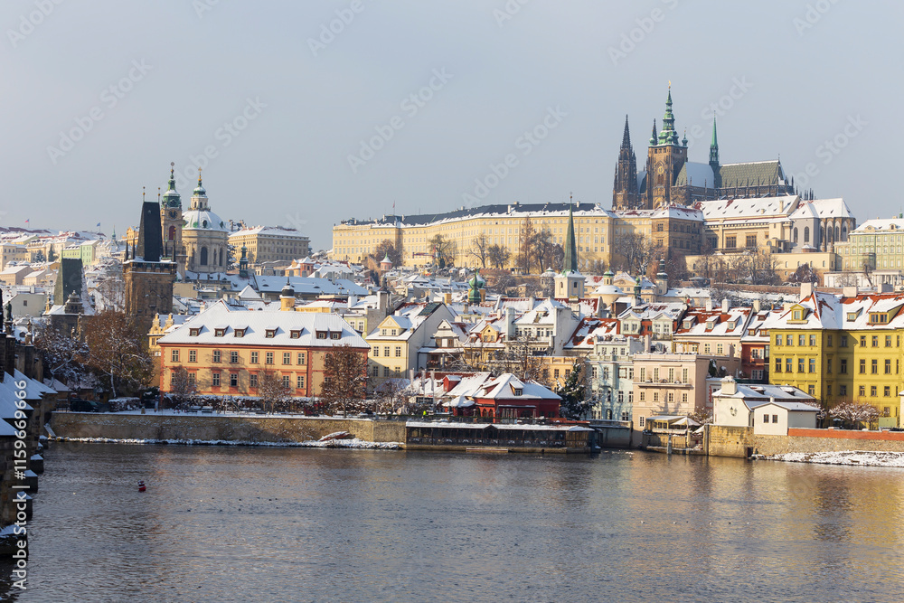 Snowy Prague Lesser Town with Prague Castle above River Vltava, Czech republic 