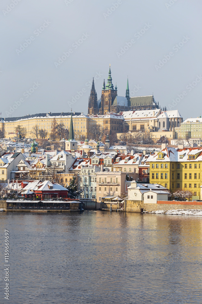 Fototapeta premium Snowy Prague Lesser Town with Prague Castle above River Vltava, Czech republic 