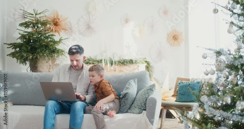 Little Boy Helping Dad While Working on Laptop photo