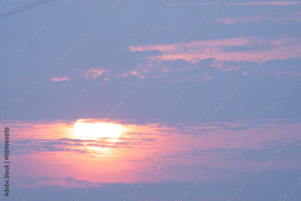Sun shining through light cloud in blue sky Sun shining through light cloud in blue sky
