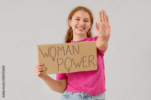 Young girl holding paper wi...