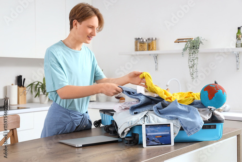 Male tourist packing suitca...