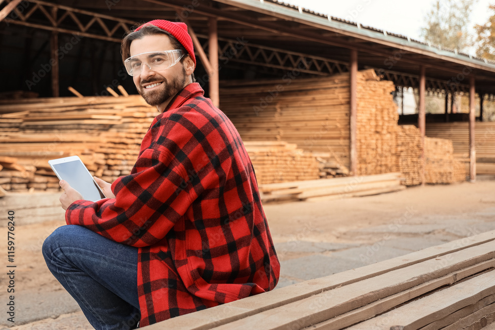 Male carpenter working with tablet computer at sawmill Male carpenter working with tablet computer at sawmill