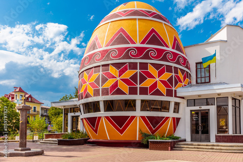 A large, colorful egg-shaped building with a red and yellow design photo