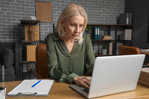 Worried mature businesswoma...