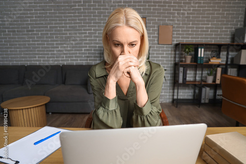 Worried mature businesswoma...