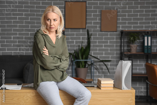 Worried mature businesswoma...