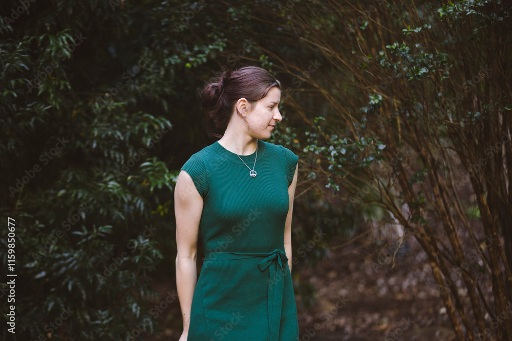 A woman stands amidst dense greenery, her confident pose and a hint of a smile blending beautifully with the vibrant natural surroundings and sunlight A woman stands amidst dense greenery, her confident pose and a hint of a smile blending beautifully with the vibrant natural surroundings and sunlight