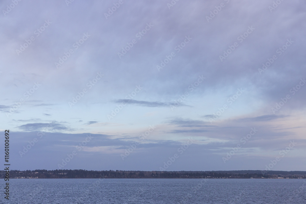 Serene Coastal Landscape with Calm Waters Under a Peaceful Sky Serene Coastal Landscape with Calm Waters Under a Peaceful Sky