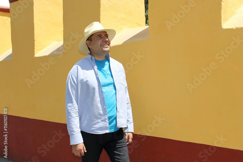 Dark-skinned Latino 40-year-old man with a hat walks as a tourist through the streets of a provincial town in Latin America, knows and discovers while traveling