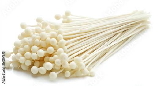 Delicate enoki mushrooms with slender stems and small, rounded caps stand upright, creating an elegant arrangement, isolated on a white background to showcase their fine details.

 photo