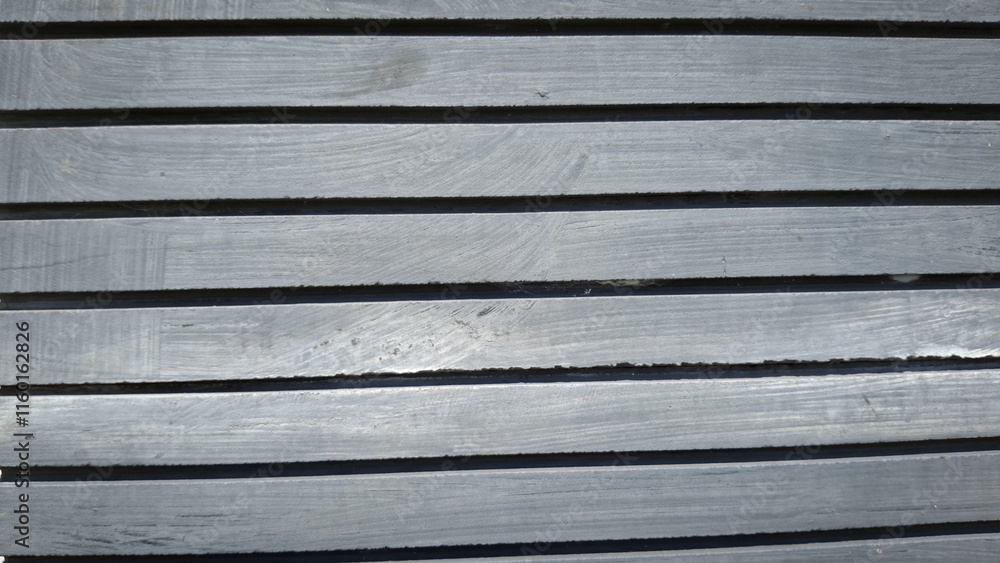 Fototapeta premium A close-up view of a weathered wooden wall, showcasing a rich texture of horizontal planks and visible grain patterns