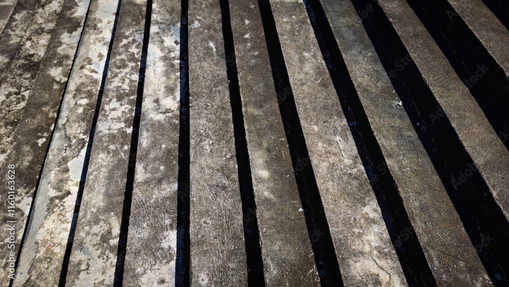 Fototapeta premium A close-up view of a weathered wooden boardwalk, showcasing a rich texture of horizontal planks and visible grain patterns