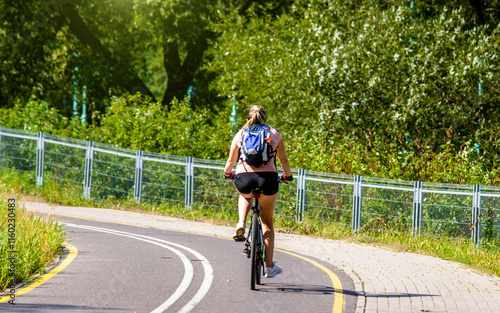 Wallpaper Mural Cyclist ride on the bike path in the city Park
 Torontodigital.ca