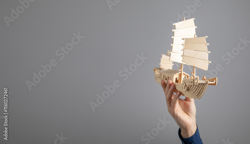 Fotografi Man showing wooden boat. Business