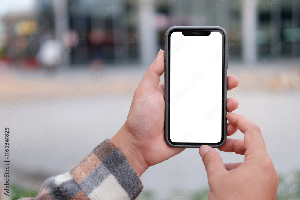 Man holds and touches a smartphone with a vertical white screen to take a photo. Man holds and touches a smartphone with a vertical white screen to take a photo.