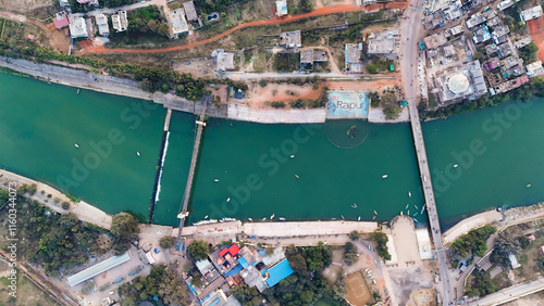 Aerial view of Mahadev Ghat Raipur, Drone shot of Mahadev Ghat riverfront, Scenic drone capture of Raipur ghat, Riverfront and bridge aerial view Raipur, Mahadev Ghat top view with boats stock Photo. photo