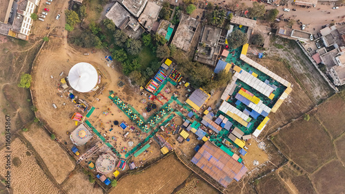 colorful fair aerial view, festival ground drone shot, rural carnival celebration, vibrant mela bird’s eye view, Indian village fair aerial, amusement rides in open ground stock Photo. photo