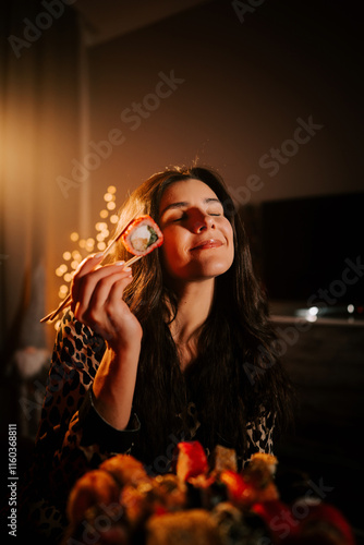 Warm ambiance sets the mood for a woman enjoying sushi in her pajamas at home