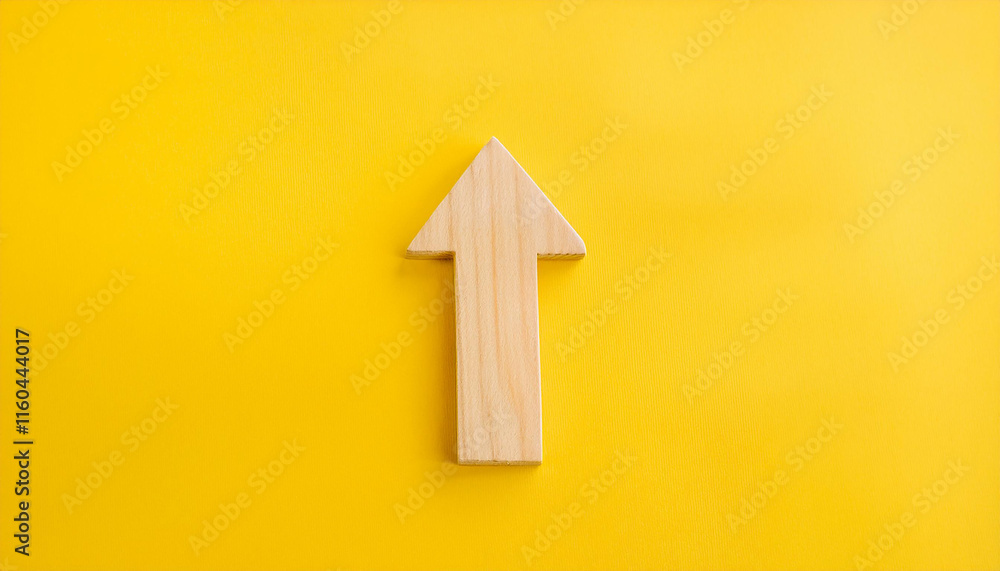 Minimalist wooden arrow on yellow background. Wood pointer, forward direction, up. Minimalist wooden arrow on yellow background. Wood pointer, forward direction, up.