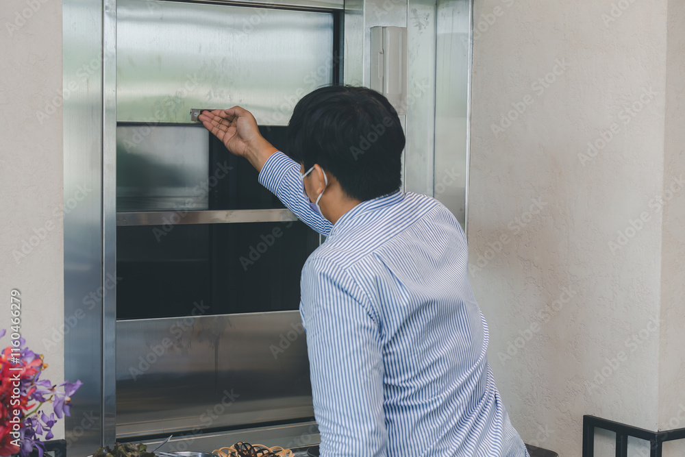 Chef use Dumbwaiter Lift elevator in a kitchen of Restaurant or Hotel used for carrying food ready Serve to customer. Waiters carry food from the Dumbwaiter Lift elevator and prepare to serve Chef use Dumbwaiter Lift elevator in a kitchen of Restaurant or Hotel used for carrying food ready Serve to customer. Waiters carry food from the Dumbwaiter Lift elevator and prepare to serve