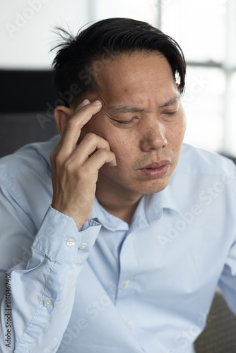 Fotografija Overworked Asian Man thinking and planning with serious and stressed expression,