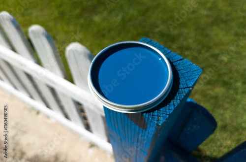 Obraz na płótnie Blue paint can lid resting over fence pole w salonie