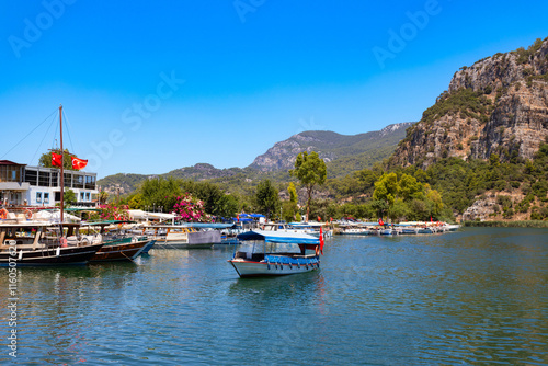 Boats at Dalyan river in Dalyan town, Turkey photo