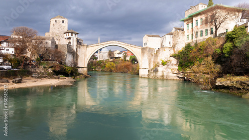 Aerial view of people crossing Old Bridge over Neretva river in Mostar, Bosnia and Herzegovina. photo