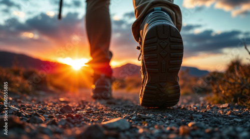 close-up of hiking boots on a trail at sunset