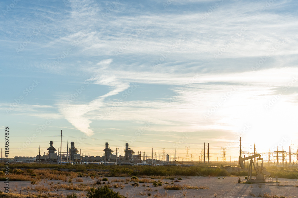 Fototapeta premium Oil wells in Texas early in the morning with sunrise in background