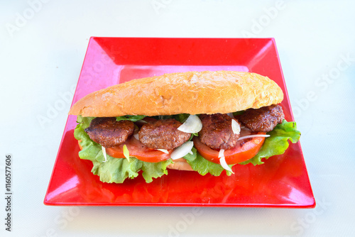 Meatball between bread (Turkish name : ekmek arasi kofte ) Izgara kofte. Manisa, Akcaabat, Akhisar  kofte. Delicious meat grilled meatballs. photo