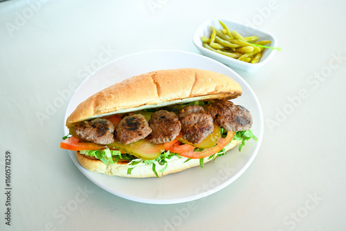 Meatball between bread (Turkish name : ekmek arasi kofte ) Izgara kofte. Manisa, Akcaabat, Akhisar  kofte. Delicious meat grilled meatballs. photo