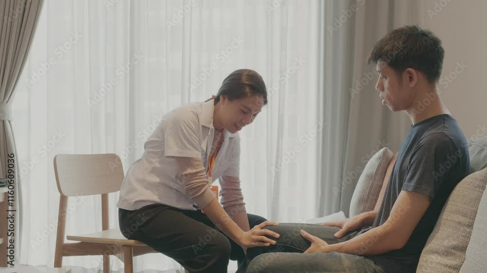 A woman is helping a man with his arm. The woman is wearing a white shirt and the man is wearing a black shirt A woman is helping a man with his arm. The woman is wearing a white shirt and the man is wearing a black shirt