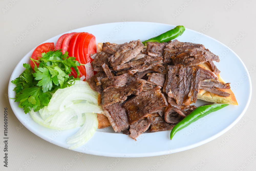 Turkish Traditional Ramadan doner kebab with tasty tomato sauce and rice or turkish pilav in white plate on table background. Lavash doner kebab ( doner zurna durum ) Pilavustu Doner Iskender kebap Turkish Traditional Ramadan doner kebab with tasty tomato sauce and rice or turkish pilav in white plate on table background. Lavash doner kebab ( doner zurna durum ) Pilavustu Doner Iskender kebap