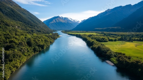 Scenic river flows through lush valleys and mountains during daylight hours