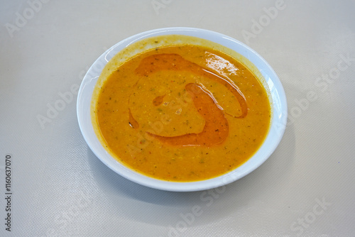 Turkish Ezo Gelin soup, Traditional Turkish Soup. Geleneksel Ezogelin corbasi. Ezogelin Soup Served with a slice of lemon. Top view photo