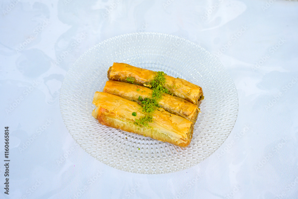 Turkish Dessert Sobiyet, havuc dilimi, midye baklava, mussels baklava and classic baklava with Pistachio . Cikolatali cevizli, fistikli soguk Baklava, top view. Turkish Dessert Sobiyet, havuc dilimi, midye baklava, mussels baklava and classic baklava with Pistachio . Cikolatali cevizli, fistikli soguk Baklava, top view.