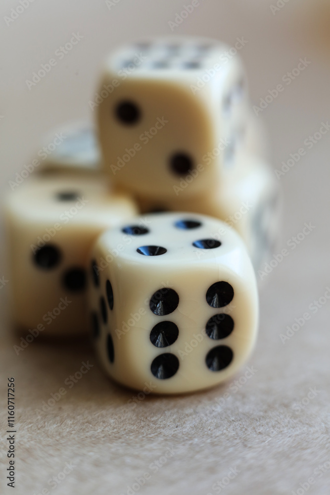 Dice on beige background with shallow depth of field and copy space Dice on beige background with shallow depth of field and copy space