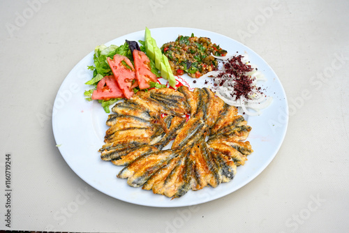 Fried Anchovies (Turkish Name: Hamsi Tava) .Hamsi, istavrit, sardalya tava. Balik kizartma. Izgara cipura levrek, palamut  yesil salata. photo