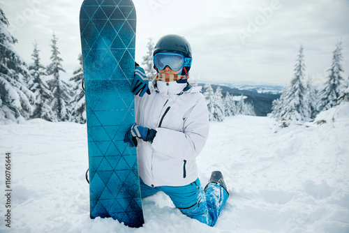 Portrait Of Woman On The Background Of Mountains. Holding a Snowboard And Wearing Ski Glasses.