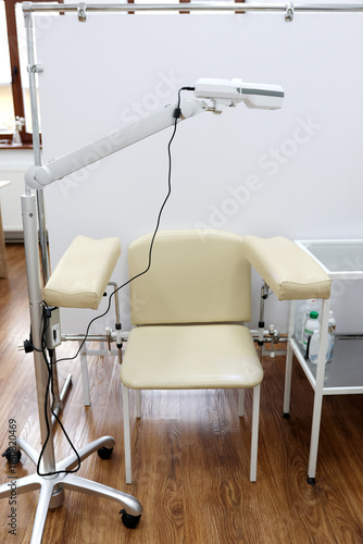 Portable non-contact device for visualization of veins with a chair and a stand. photo