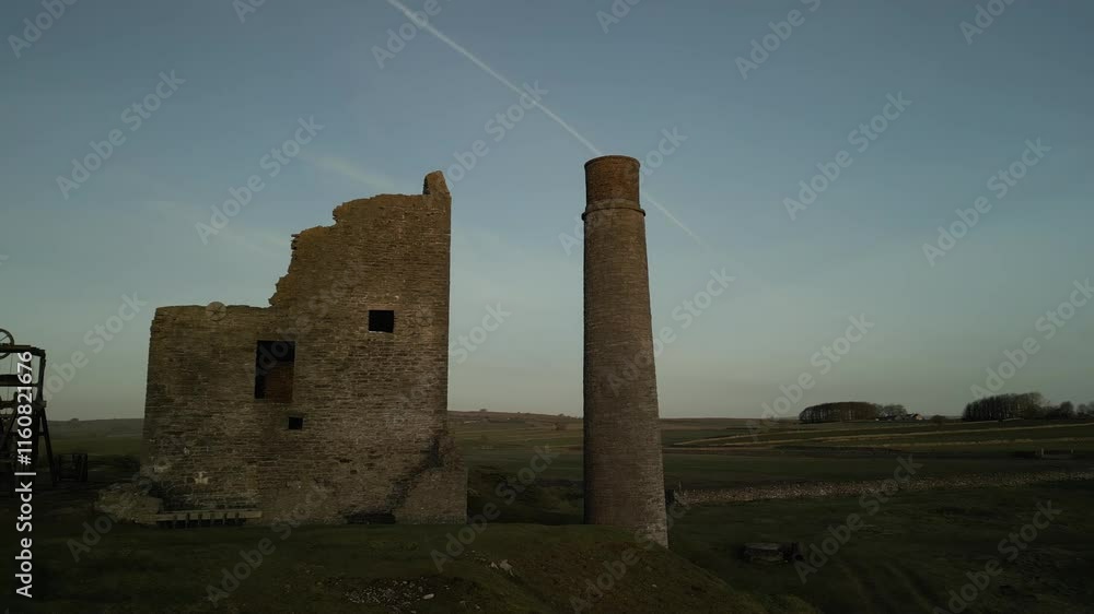 Drone flight on the abandoned historic Magpie Mine in expansive grassland at dawn in Derbyshire, UK Drone flight on the abandoned historic Magpie Mine in expansive grassland at dawn in Derbyshire, UK