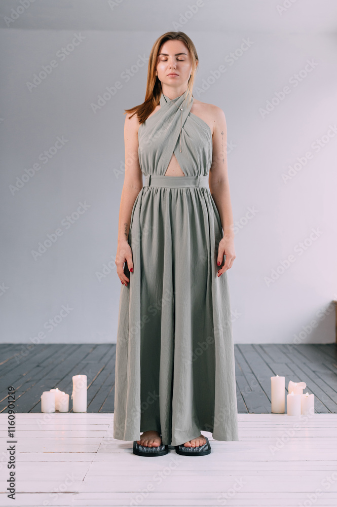 A young woman stands on the sadhu boards. Practice standing on nails. Full length portrait. A young woman stands on the sadhu boards. Practice standing on nails. Full length portrait.