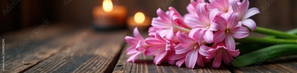 A bouquet of pale pink hyacinths sits atop a dark wooden table with candles lit, bouquet, warm A bouquet of pale pink hyacinths sits atop a dark wooden table with candles lit, bouquet, warm