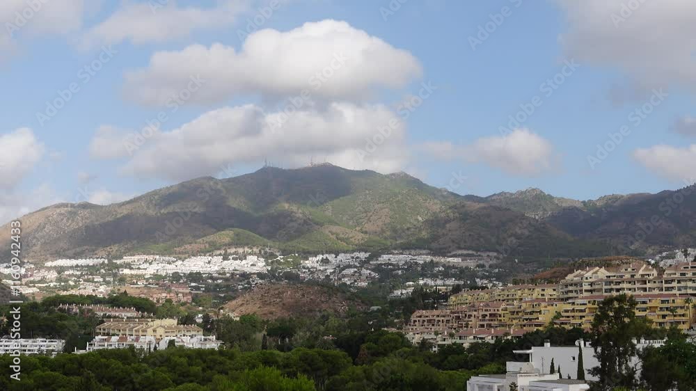 Time lapse of clouds moving fast over a mountain in a residential area with lots of vegetation
Time lapse of clouds moving fast over a mountain in a residential area with lots of vegetation