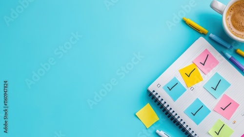 A colorful notebook with checkmarks and sticky notes, accompanied by a cup of coffee and pens, set against a bright blue background. photo