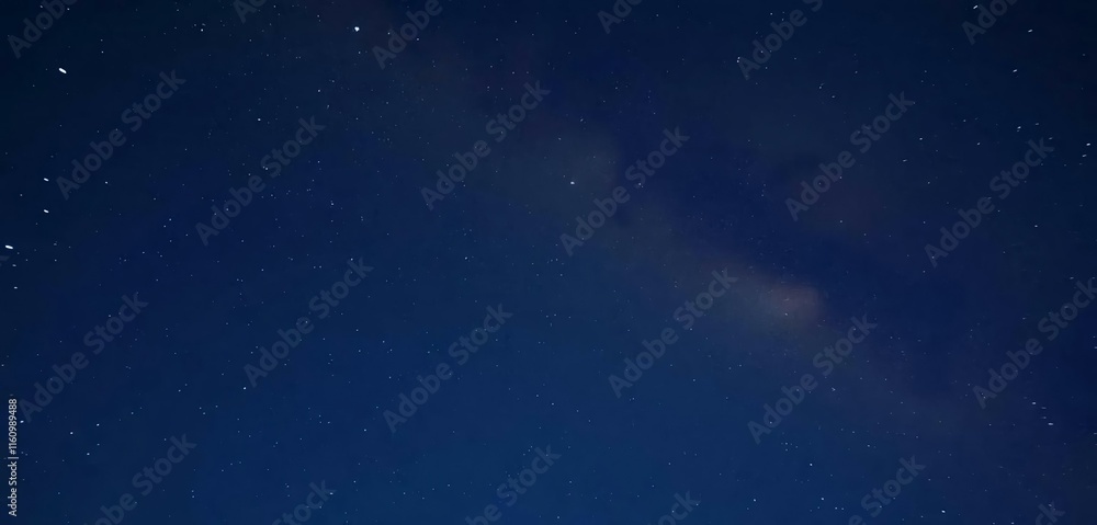 Fototapeta premium The night sky has shooting a star and the Milky Way in the background.